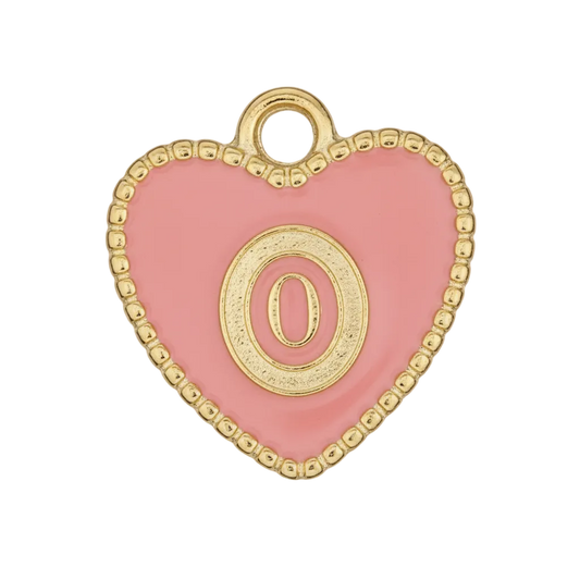close-up of a pink heart charm with a gold letter O and dotted gold border