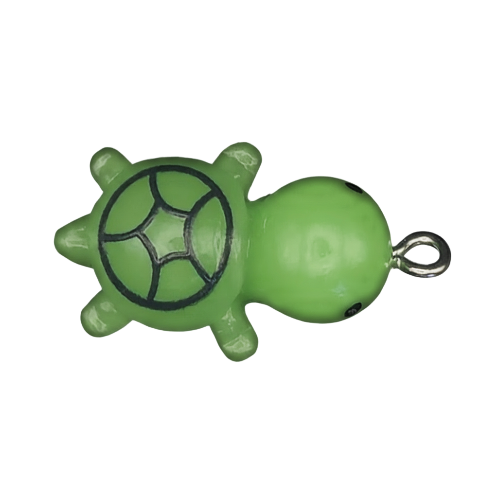 close-up of a green turtle charm with black shell lines on a black background
