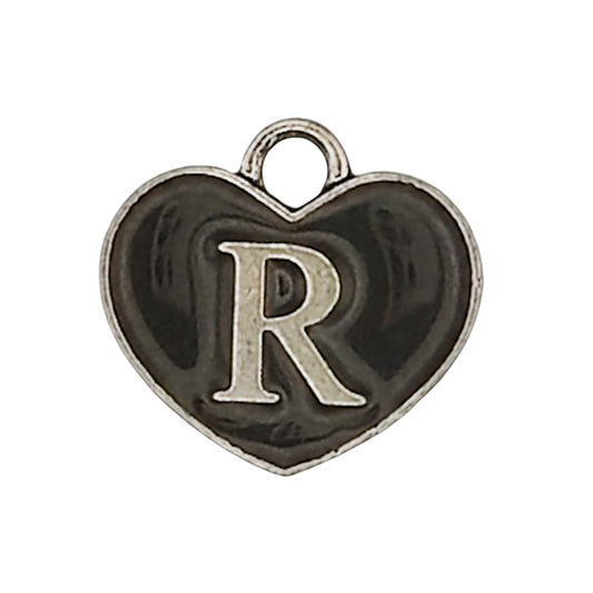close-up of black heart charm with silver letter R