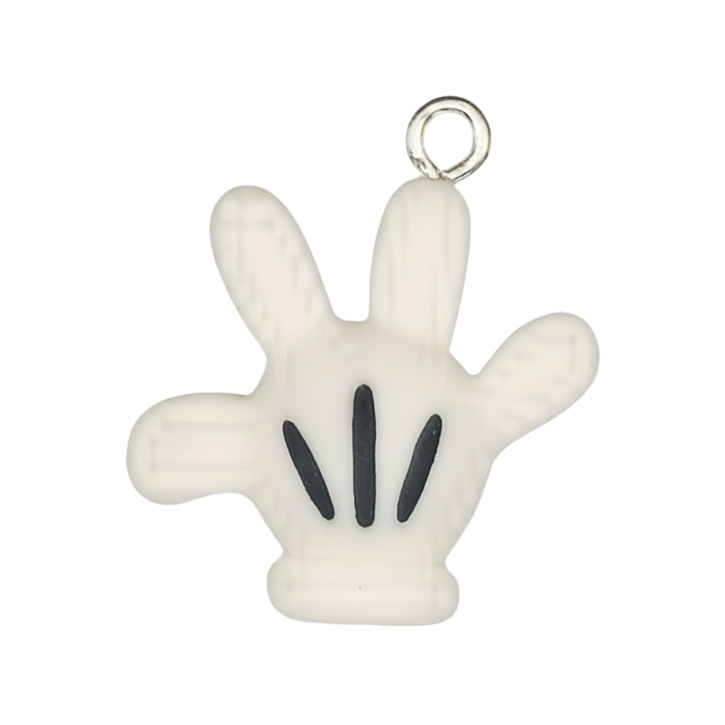 close-up of white cartoon glove hand charm with black lines on a black background