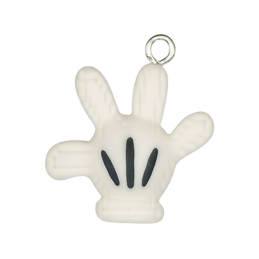 close-up of white cartoon glove hand charm with black lines on a black background