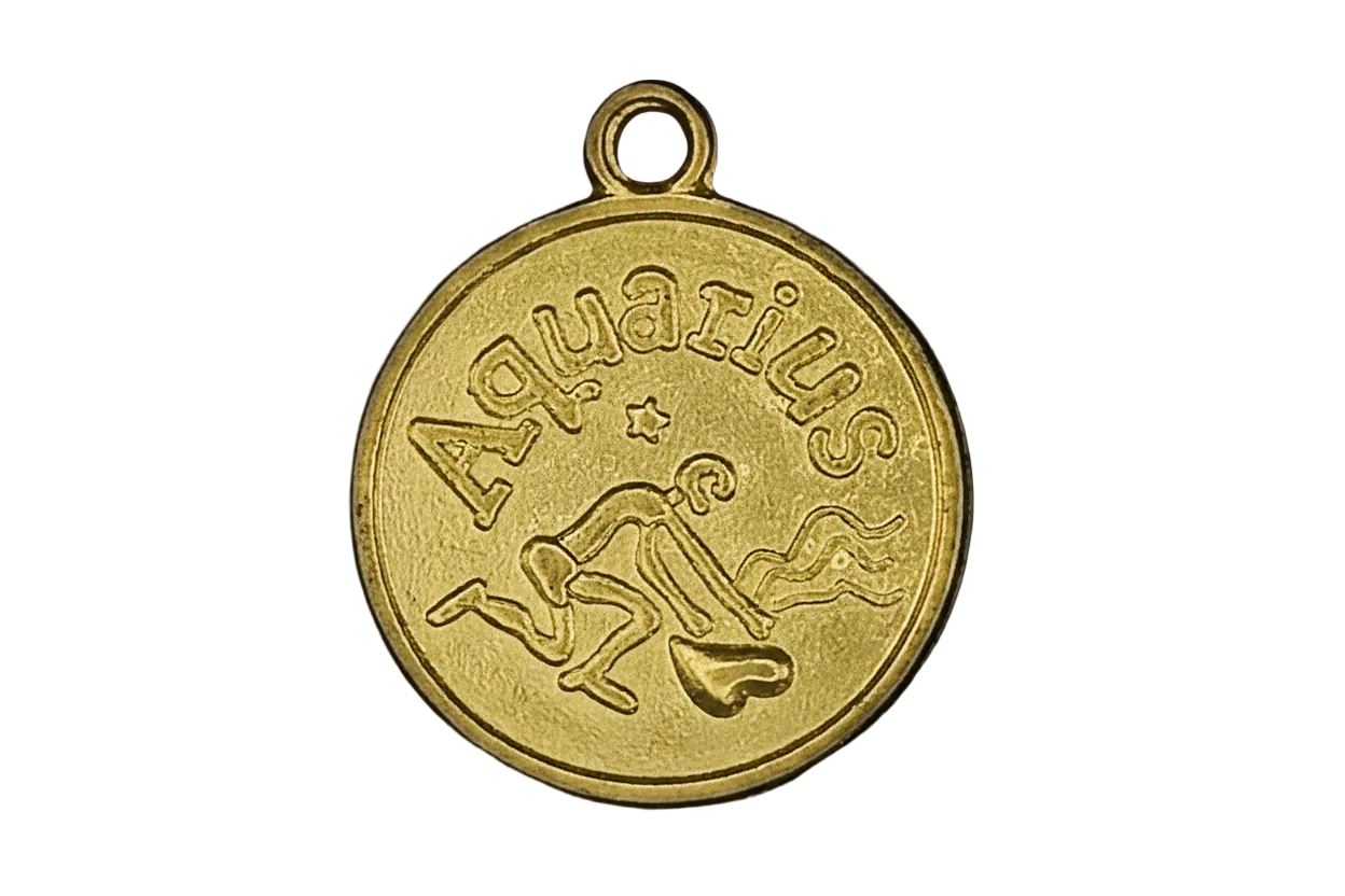 Close-up of a gold round Aquarius zodiac charm with water-bearer figure and star on a black background.