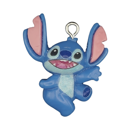 close-up of blue alien character charm with large pink ears on black background