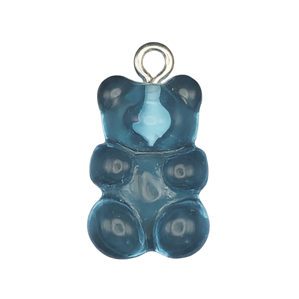 close-up blue gummy bear charm on black background