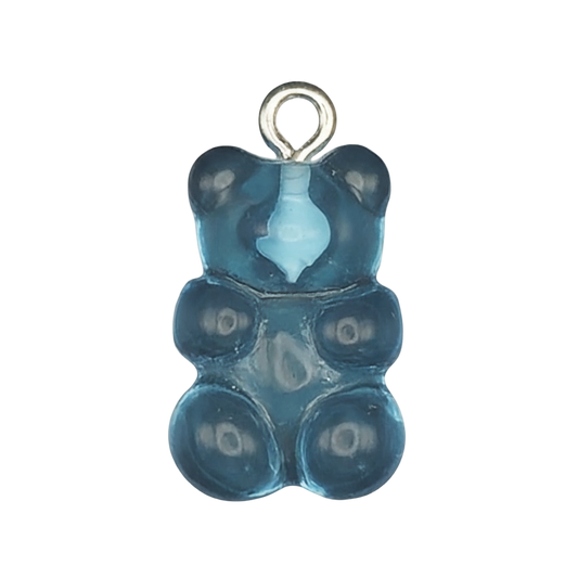 close-up blue gummy bear charm on black background