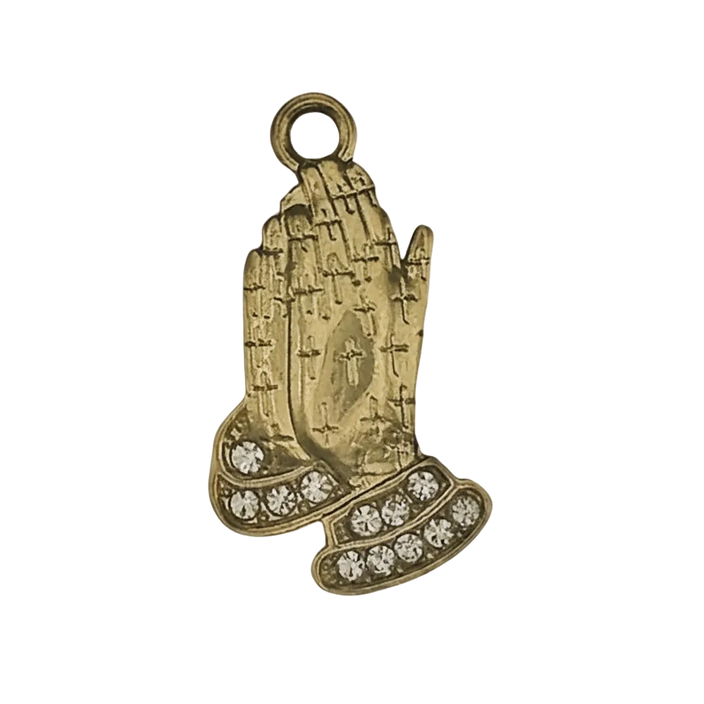 gold-tone praying hands charm with clear stones on cuffs on a black background