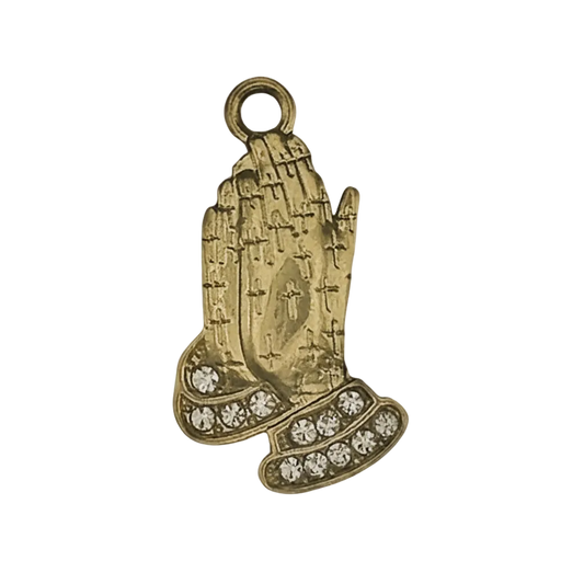 gold-tone praying hands charm with clear stones on cuffs on a black background