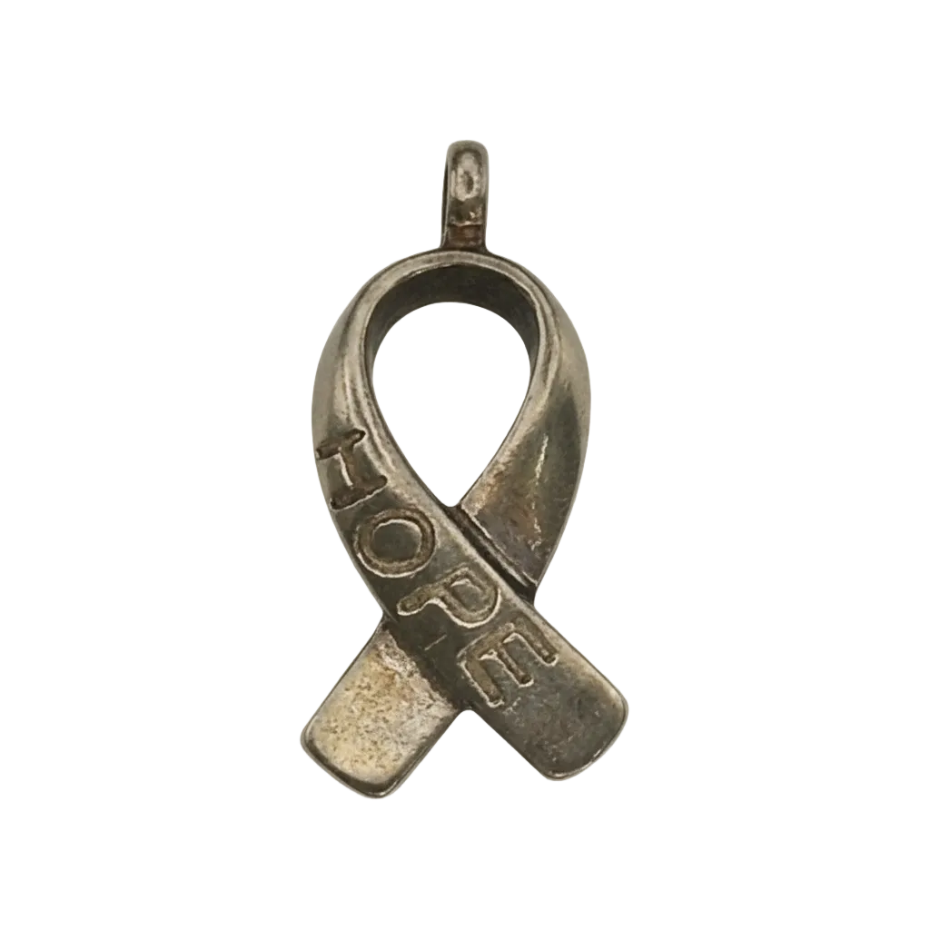 close-up of gold-tone awareness ribbon charm with 'HOPE' engraving on a black background