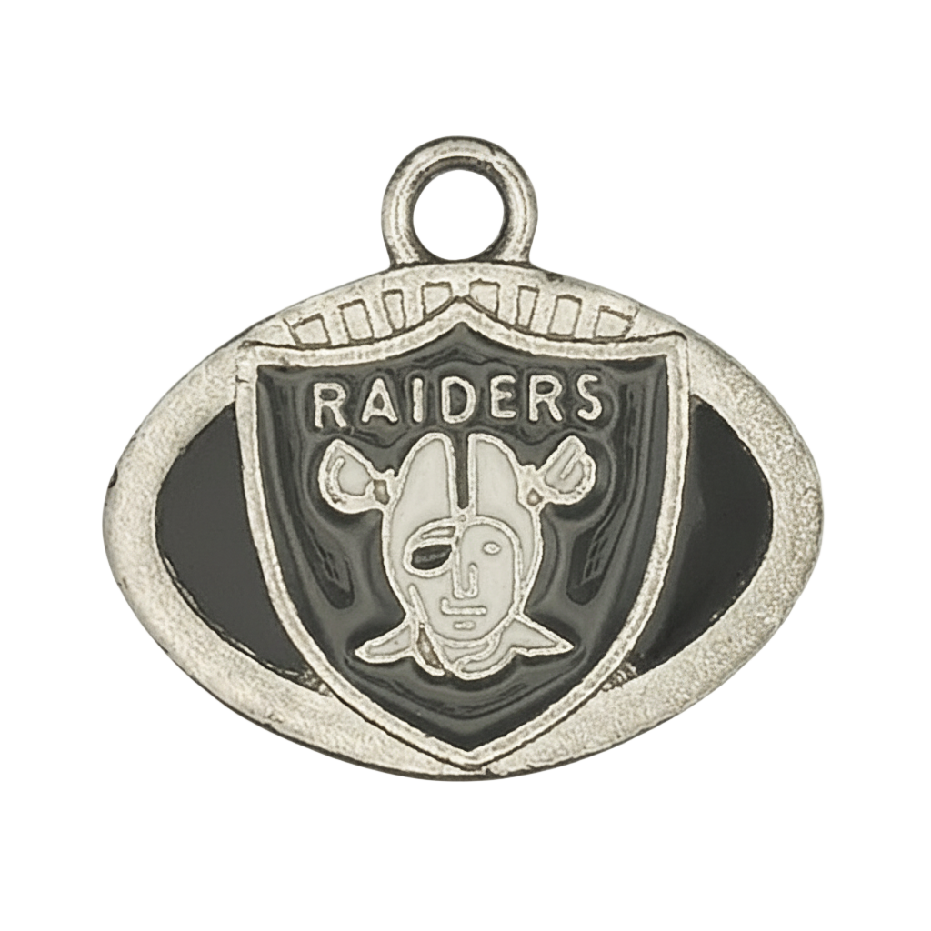 Close-up of silver-tone oval football charm with 'RAIDERS' shield and black details.