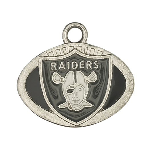 Close-up of silver-tone oval football charm with 'RAIDERS' shield and black details.