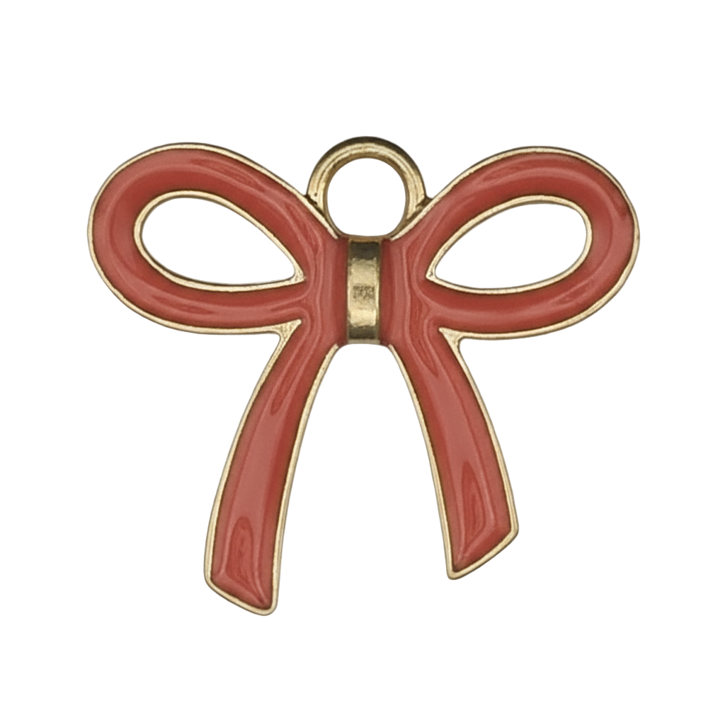 close-up of red enamel bow charm with gold-tone outline on black background