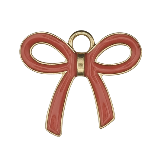 close-up of red enamel bow charm with gold-tone outline on black background