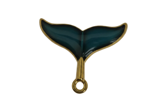 close-up of dark teal whale tail charm with gold edges on a black background