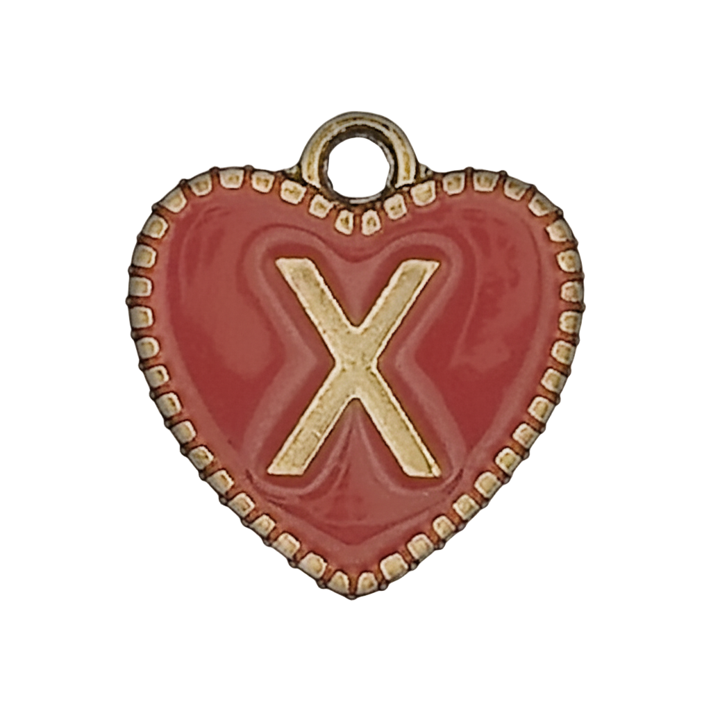 Close-up of a red heart charm with a gold letter X.
