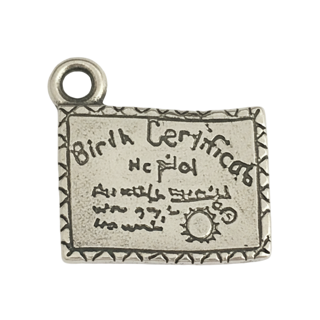 Close-up of a small silver-tone rectangular charm engraved with 'Birth Certificate' and a decorative border.