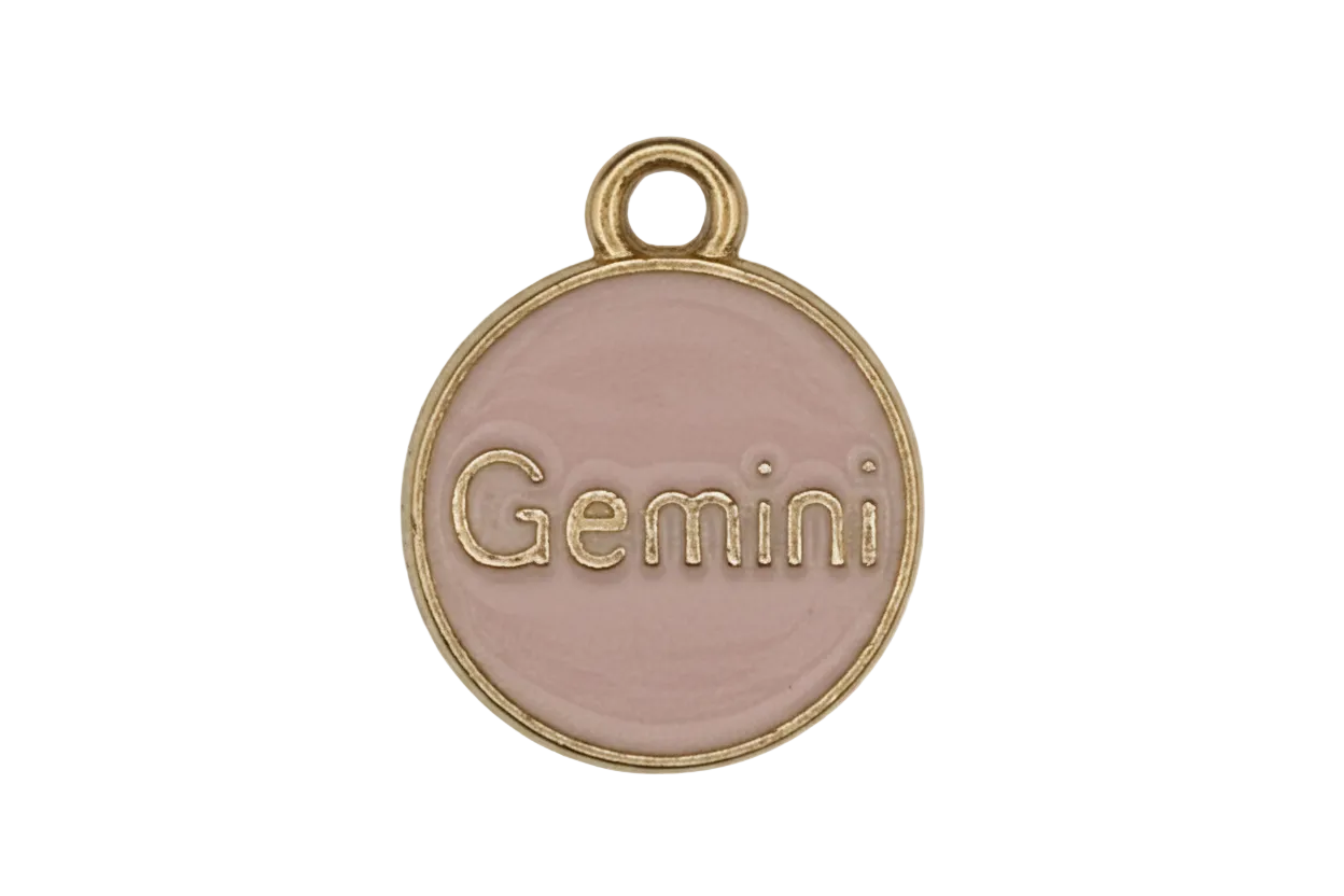close-up of pink enamel round charm with the word Gemini and gold-tone border