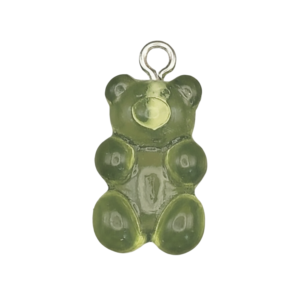 close-up of translucent green gummy bear charm on black background