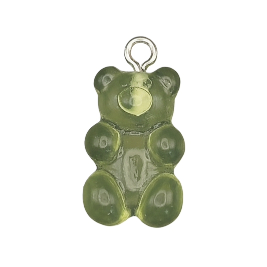 close-up of translucent green gummy bear charm on black background