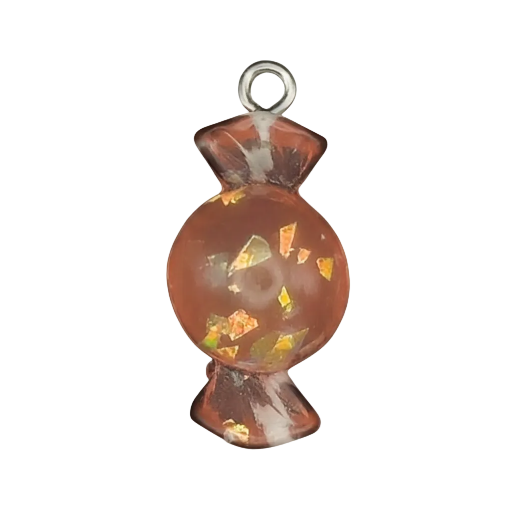 close-up orange wrapped candy resin charm with gold flakes on black background
