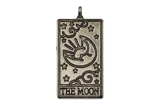Rectangular silver-tone charm with engraved crescent moon, stars, and text THE MOON on a black background.