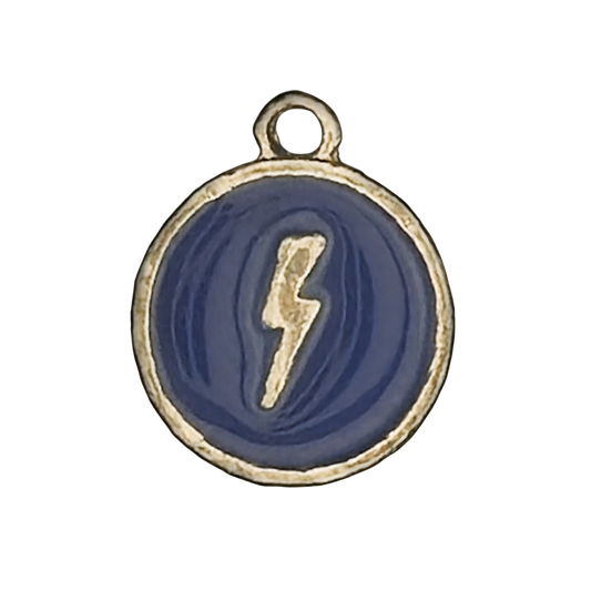 close-up of round blue charm with gold lightning bolt and gold rim