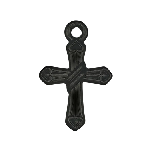 close-up of a small black cross charm with heart-shaped ends on a black background