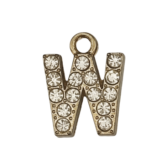 close-up of gold-tone letter W charm with clear crystals on a black background