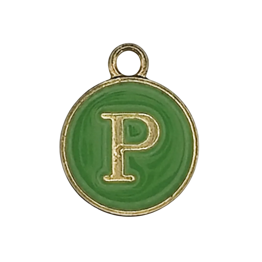 close-up of round green enamel charm with gold letter P and gold rim on a black background