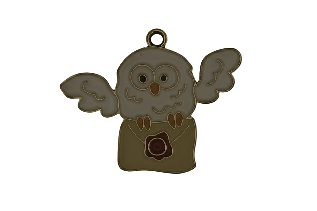 close-up of enamel owl holding a sealed envelope charm on black background