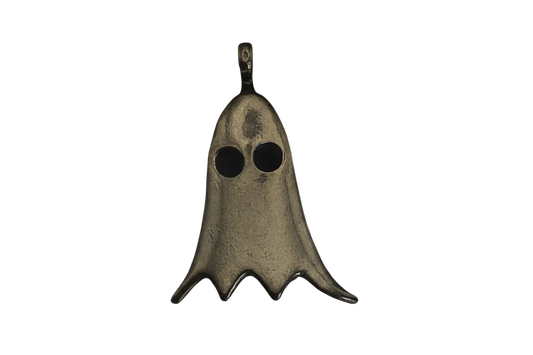 close-up bronze ghost charm with two round eyes on a black background