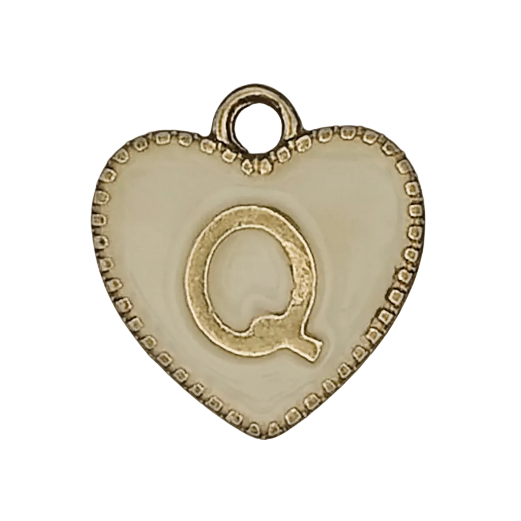 close-up of gold and cream heart charm with letter Q