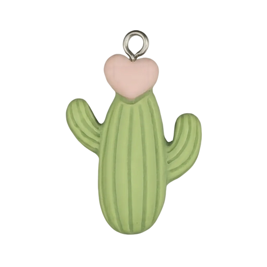 Close-up of green cactus charm with a pale pink heart top on a black background.