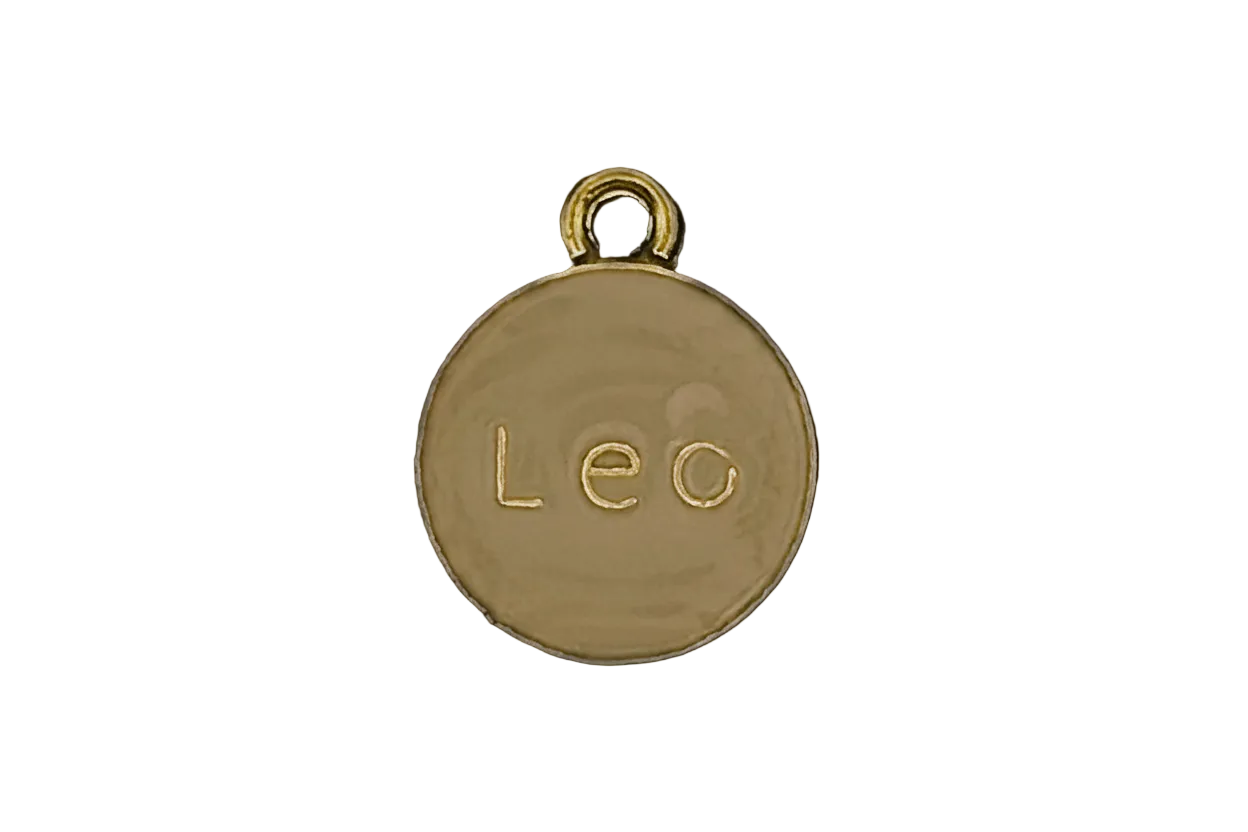 gold round charm with the word 'Leo' engraved