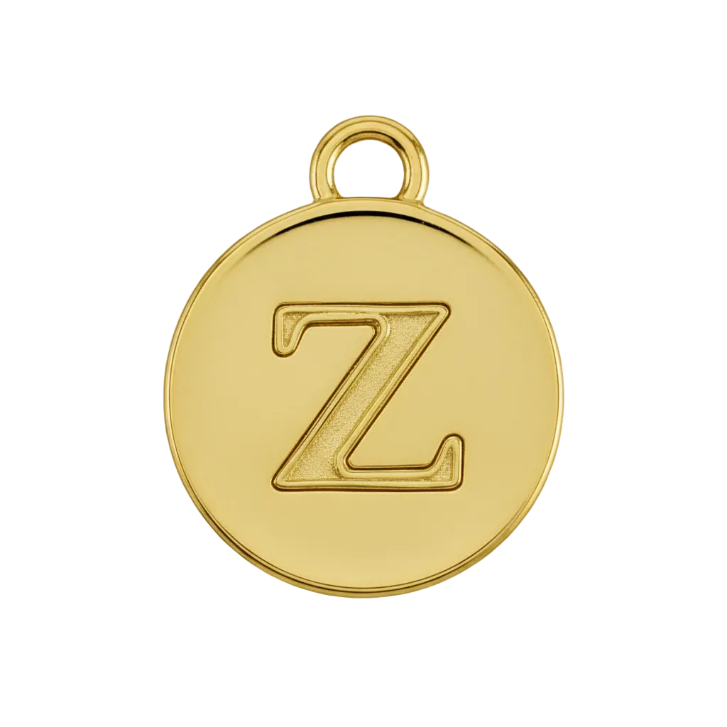 Close-up of a small round gold disc charm with the letter Z.
