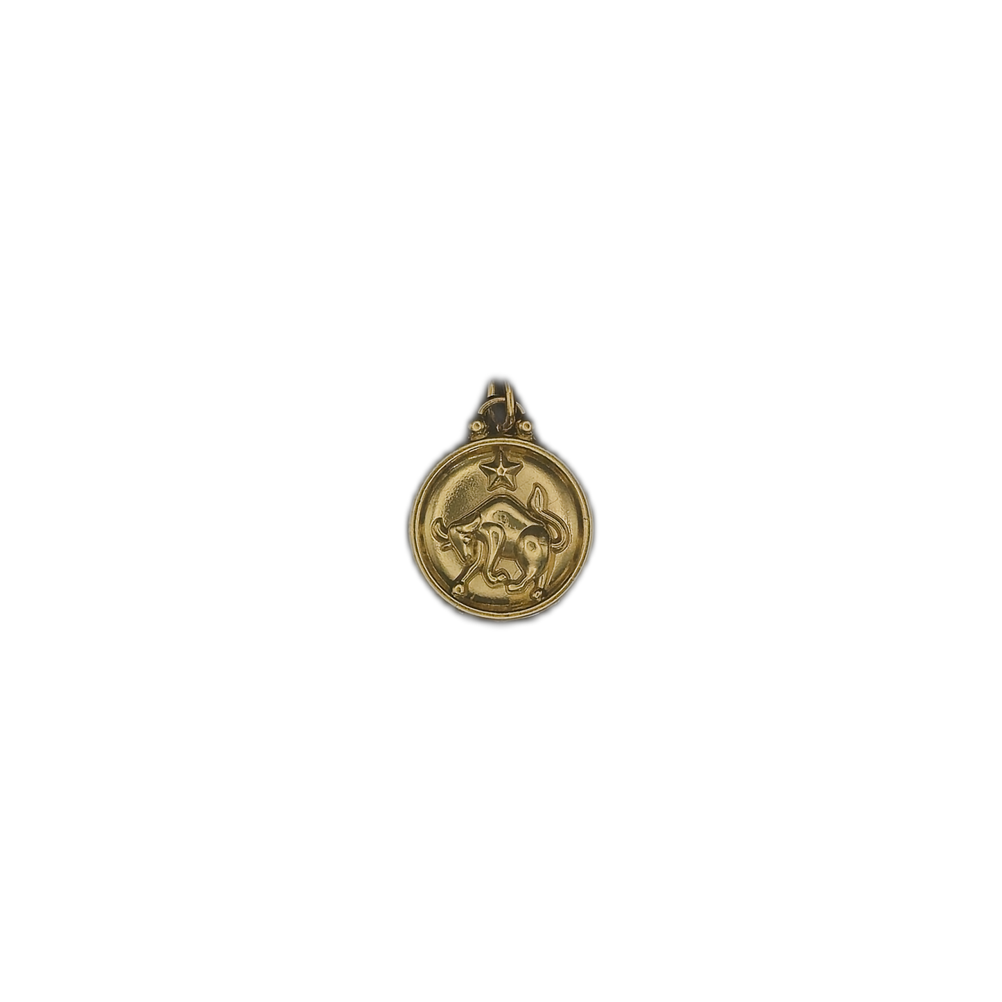 small round gold bull zodiac charm on black background
