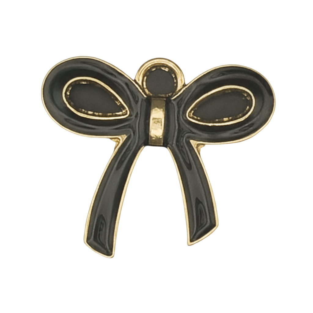 close-up of a black and gold bow-shaped charm on a black background