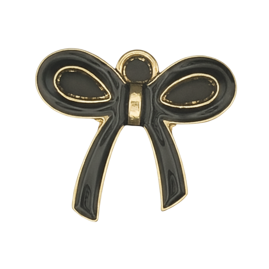 close-up of a black and gold bow-shaped charm on a black background