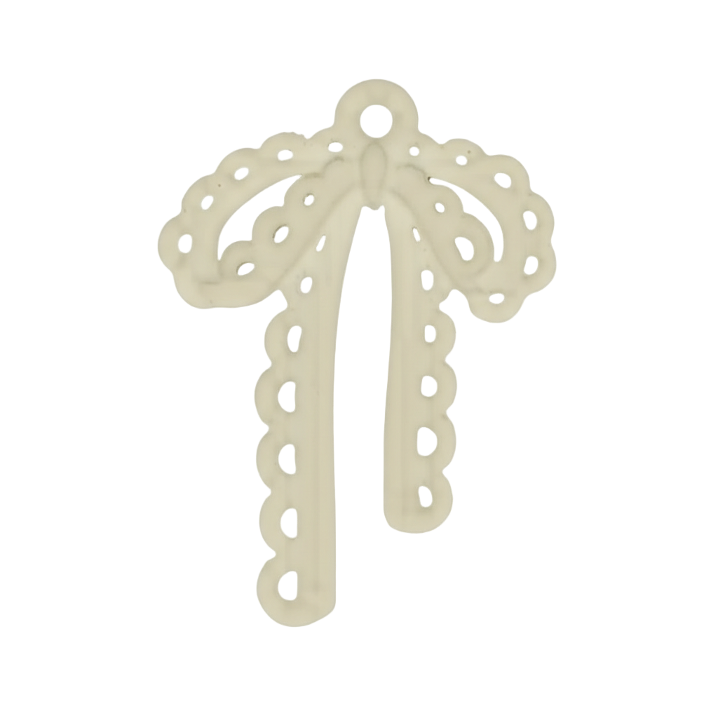 close-up of an ivory bow-shaped charm with scalloped cutouts on a black background