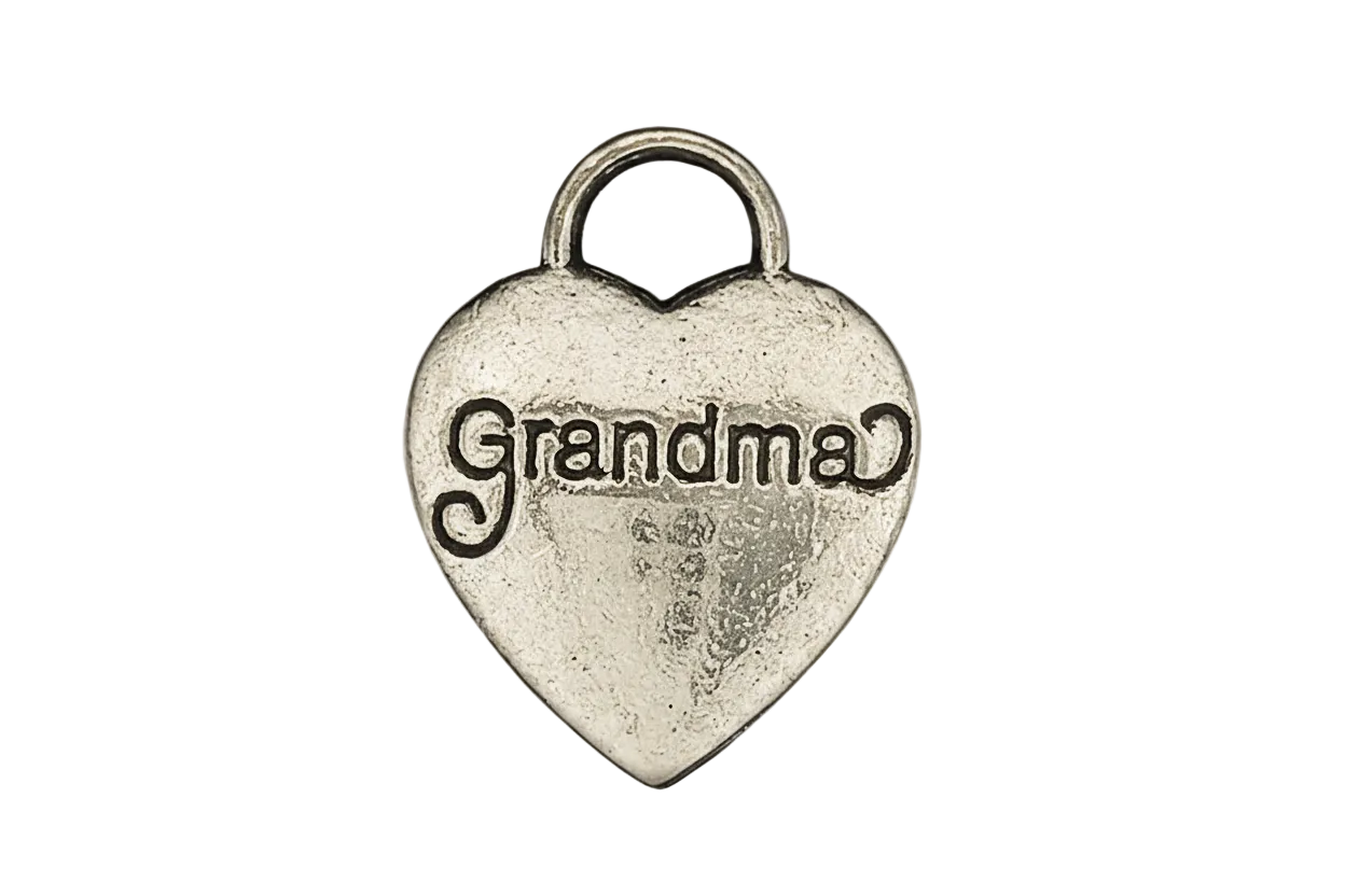close-up of a silver heart charm reading 'Grandma' on a black background