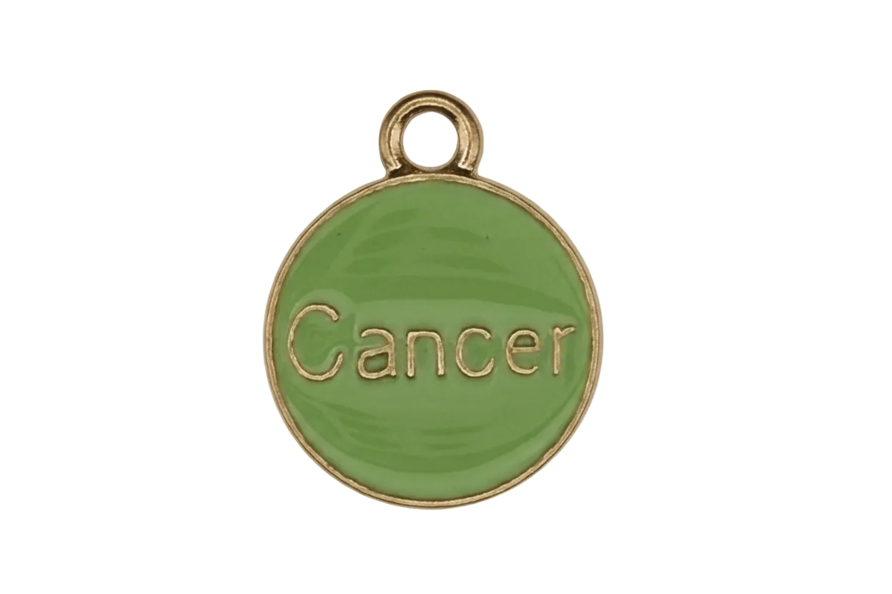 close-up of round green enamel charm reading 'Cancer' with gold edging on black background