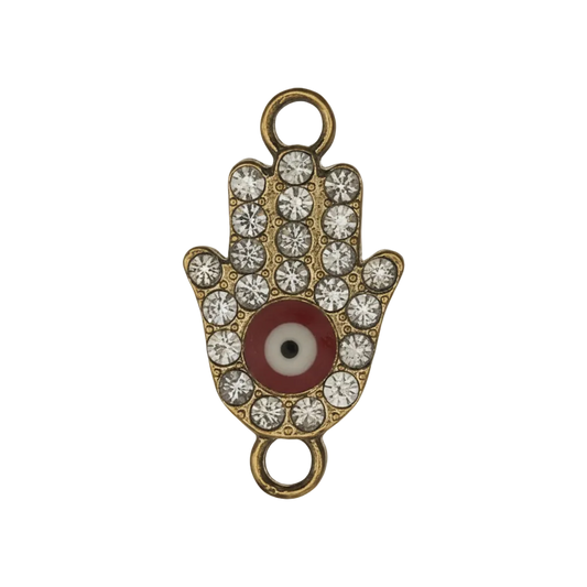 close-up of rhinestone hamsa hand charm with red and white eye on black background