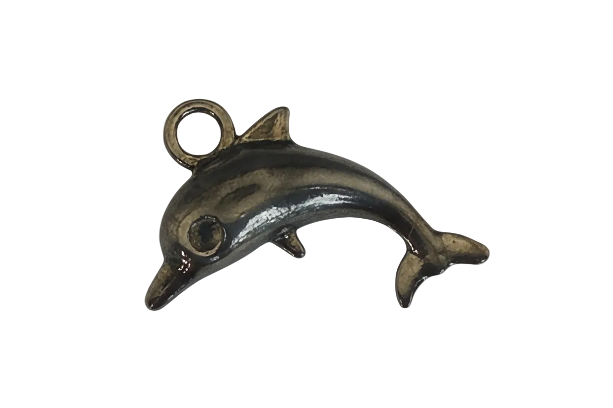 close-up of small bronze dolphin charm on black background