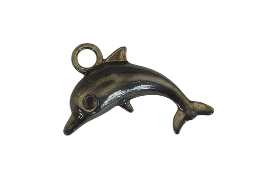 close-up of small bronze dolphin charm on black background