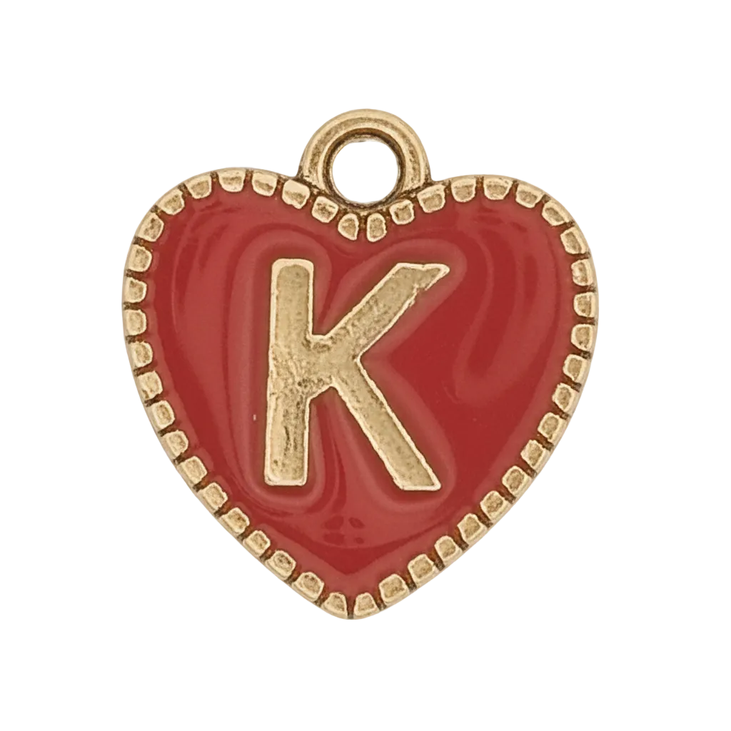 Close-up red enamel heart charm with gold letter K and beaded gold border on black background.