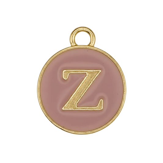 close-up of round pink enamel charm with gold letter Z