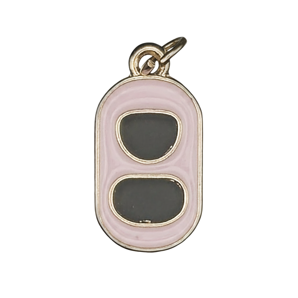 Close-up of pink and black can tab charm with gold-tone edges.