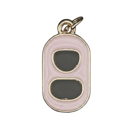 Close-up of pink and black can tab charm with gold-tone edges.