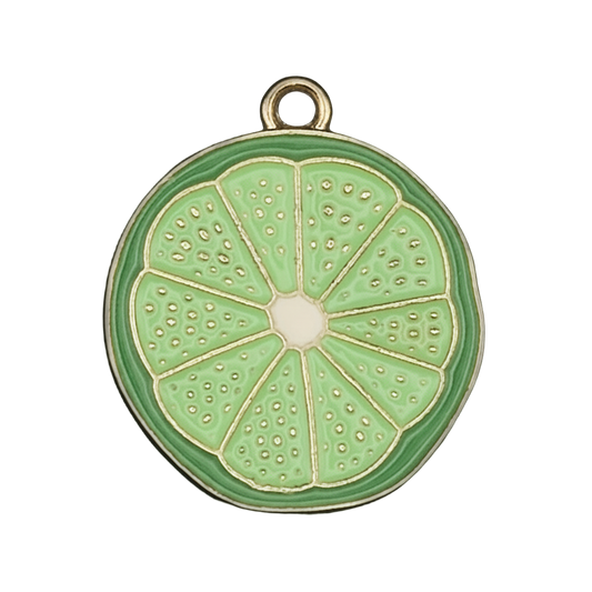 close-up of green lime slice enamel charm with gold-tone edge on black background