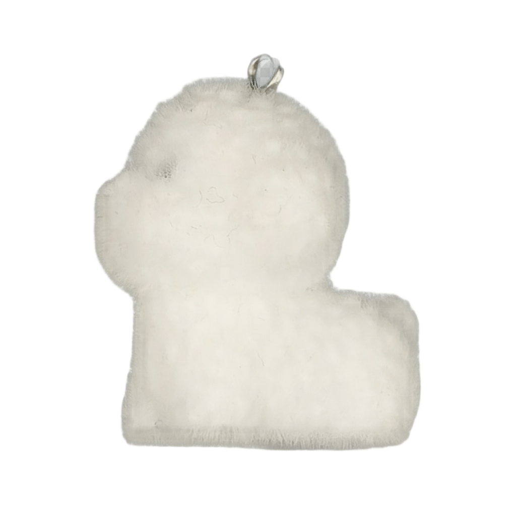 close-up of a white plush lamb-shaped charm on a black background