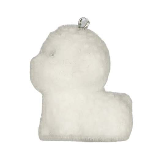 close-up of a white plush lamb-shaped charm on a black background